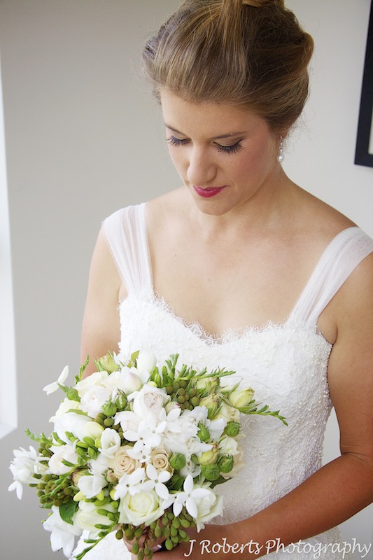 Bride looking down at her bridal bouquet - wedding photography sydney